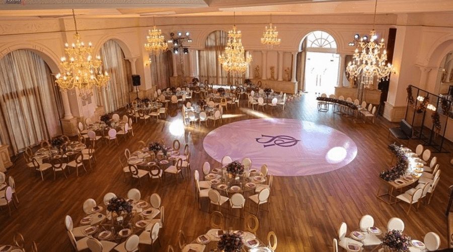 The ballroom circular dance floor and chandeliers, tables set around the edge